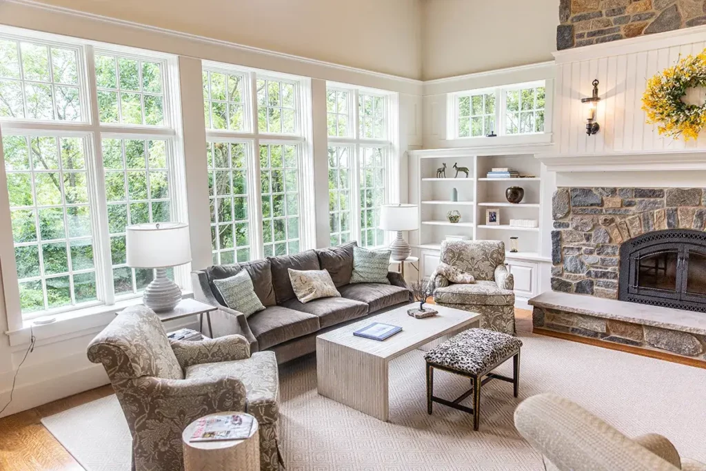 Custom living room cabinetry to create a cozy seating area with a fireplace and a wall that has windows to let in a lot of light