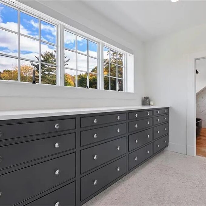 Black built-in drawers in a closet by Laslo Custom Kicthens.
