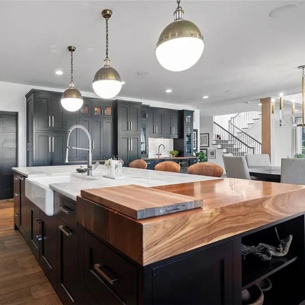Thick wood butcherblock counter on an island with black cabinets.