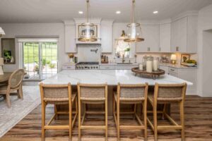 This Laslo kitchen remodel features a large island with 4 woven barstools.