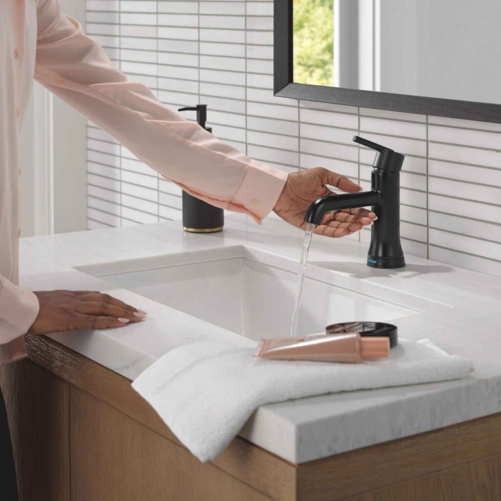 Black touchless faucet in bathroom.