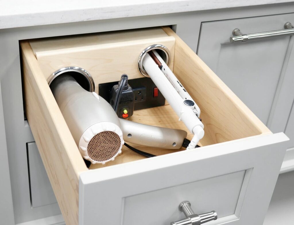 custom vanity with storage of hair dryer, internal plug and storage for hot curling iron inside the drawers