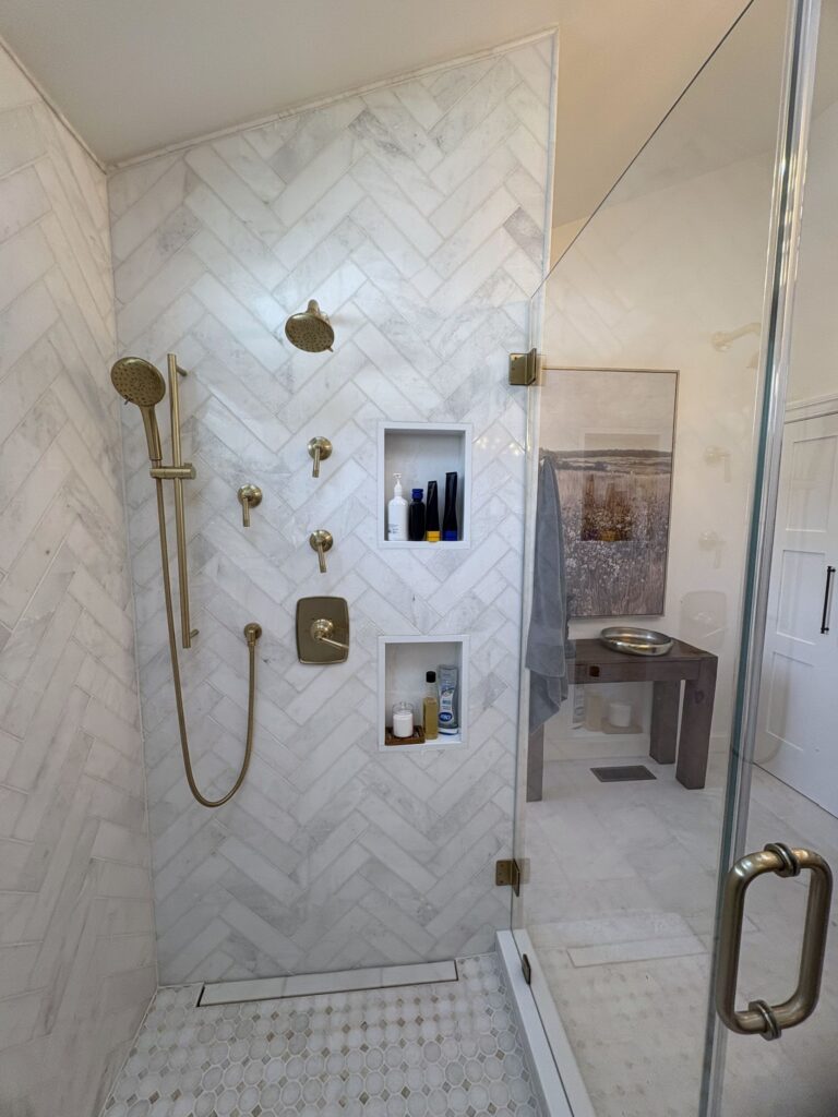 Tile shower detail beside custom bathroom vanity cabinetry in Bethlehem PA