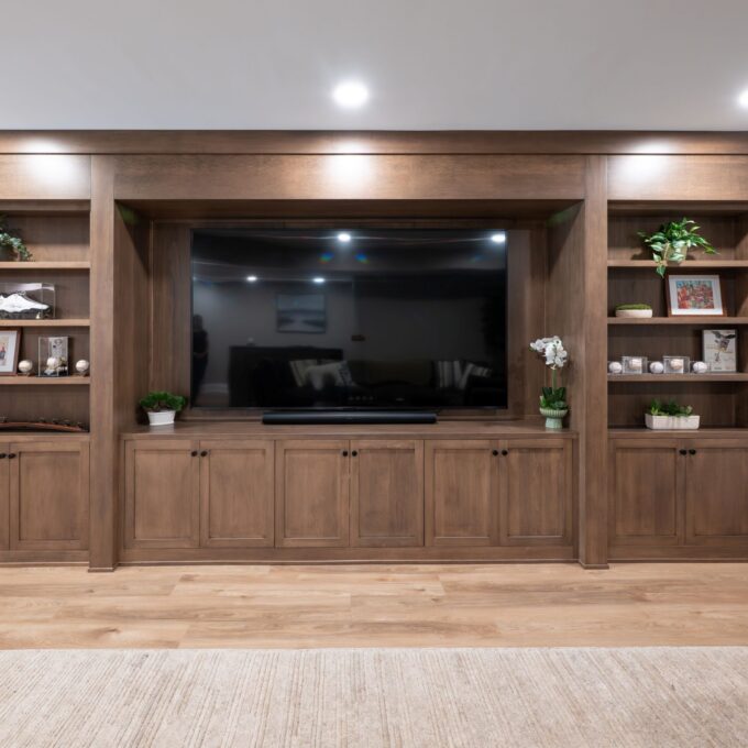 A view of the completed custom remodel in Center Valley, PA featuring a closed hard maple bookcase with hidden door and custom millwork.
