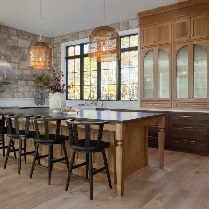 Emmaus kitchen with walnut base cabinets, quarter-sawn white oak island, arched glass doors, and integrated wall ovens.