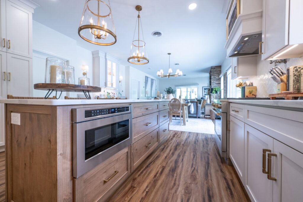 Custom wood kitchen island in Hellertown, PA with a built-in microwave, deep storage drawers, and contrasting white cabinetry.